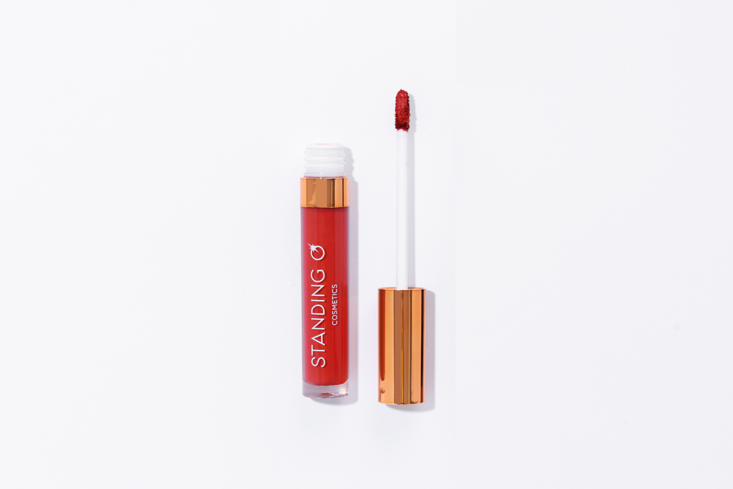 A flat lay of Resilient Red Lipstick with the top removed to showcase the applicator and color.