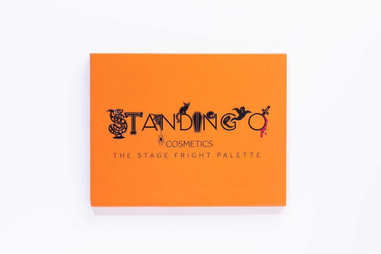 'The Stage Fright Palette' by Standing O Cosmetics, shown in orange. A spooky eye shadow palette with a Halloween logo.