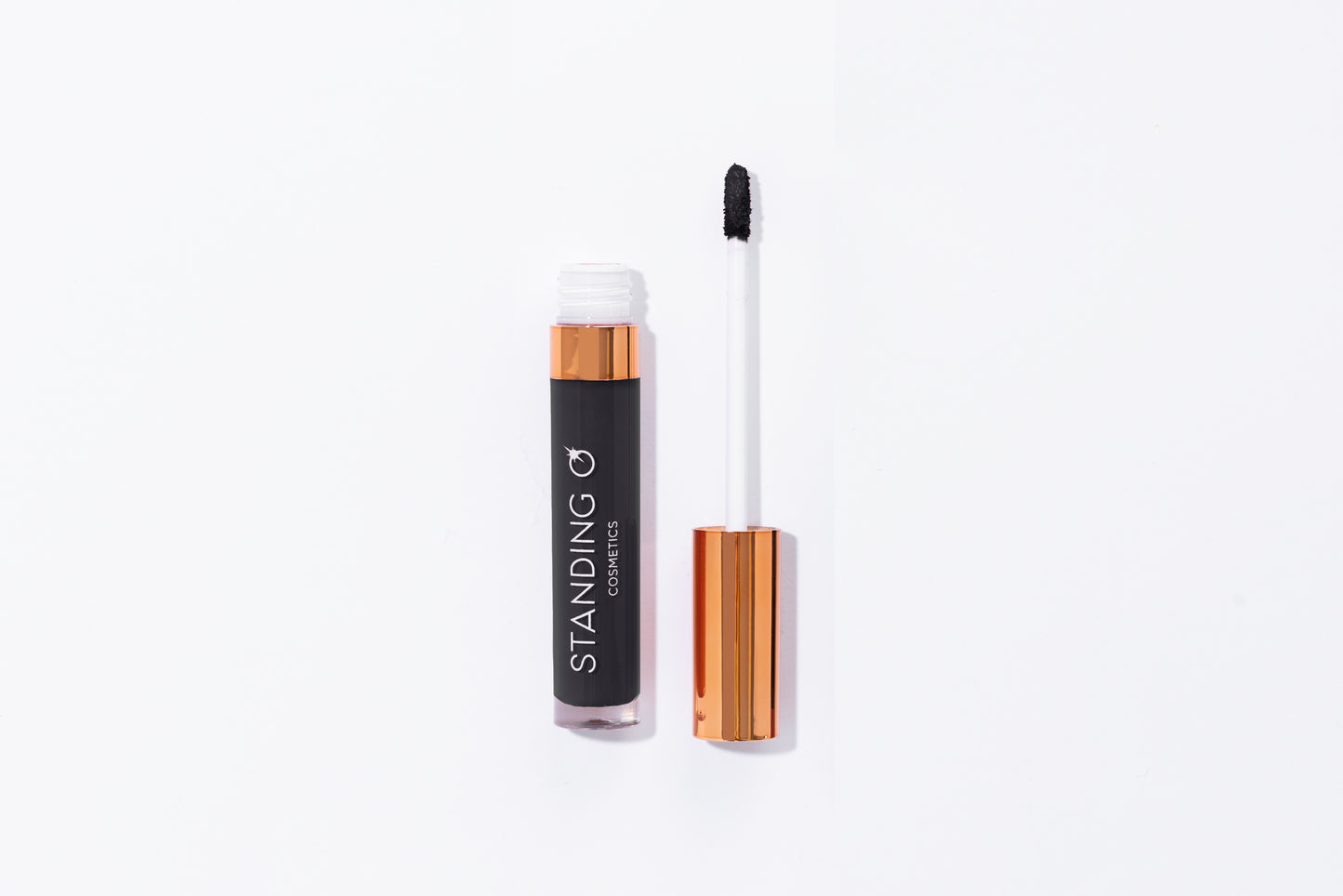 Tube of lipstick with a gold top shown open to showcase the applicator and color: black lipstick.