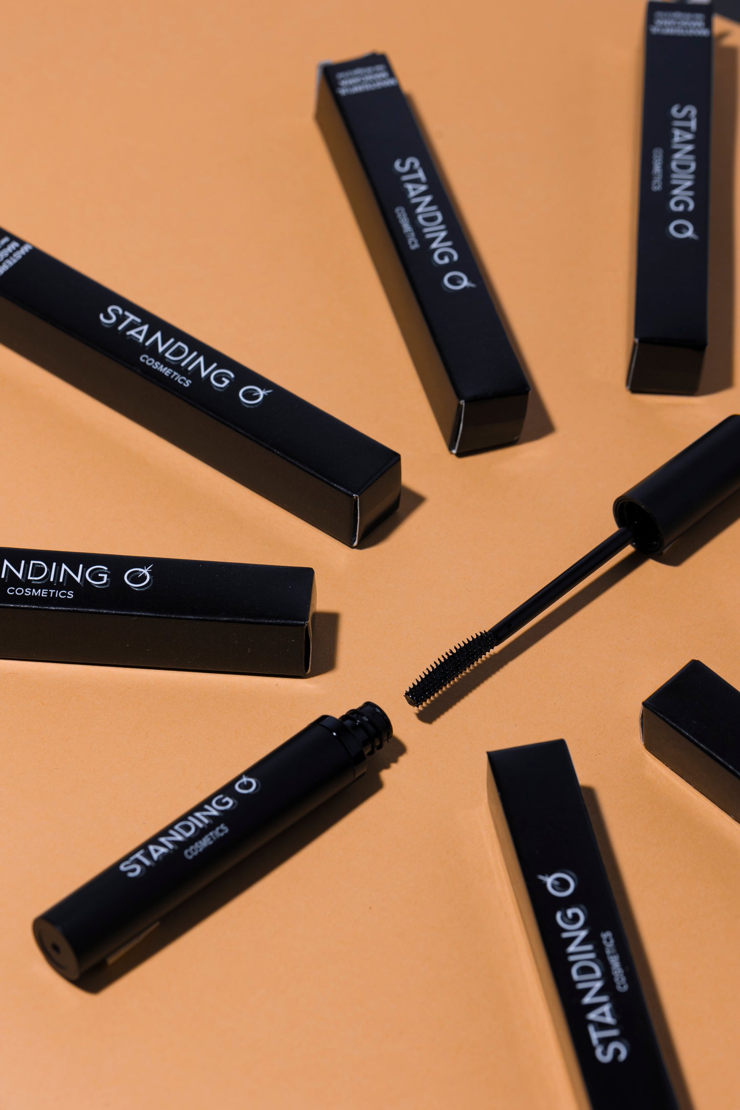 Assorted mascara boxes with one open, displaying the wand.