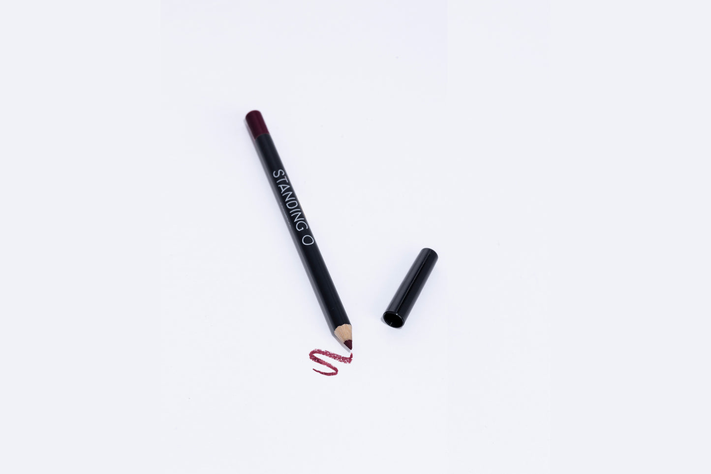 Lip liner pencil with swatch to showcase color of liner, dark purple liner..