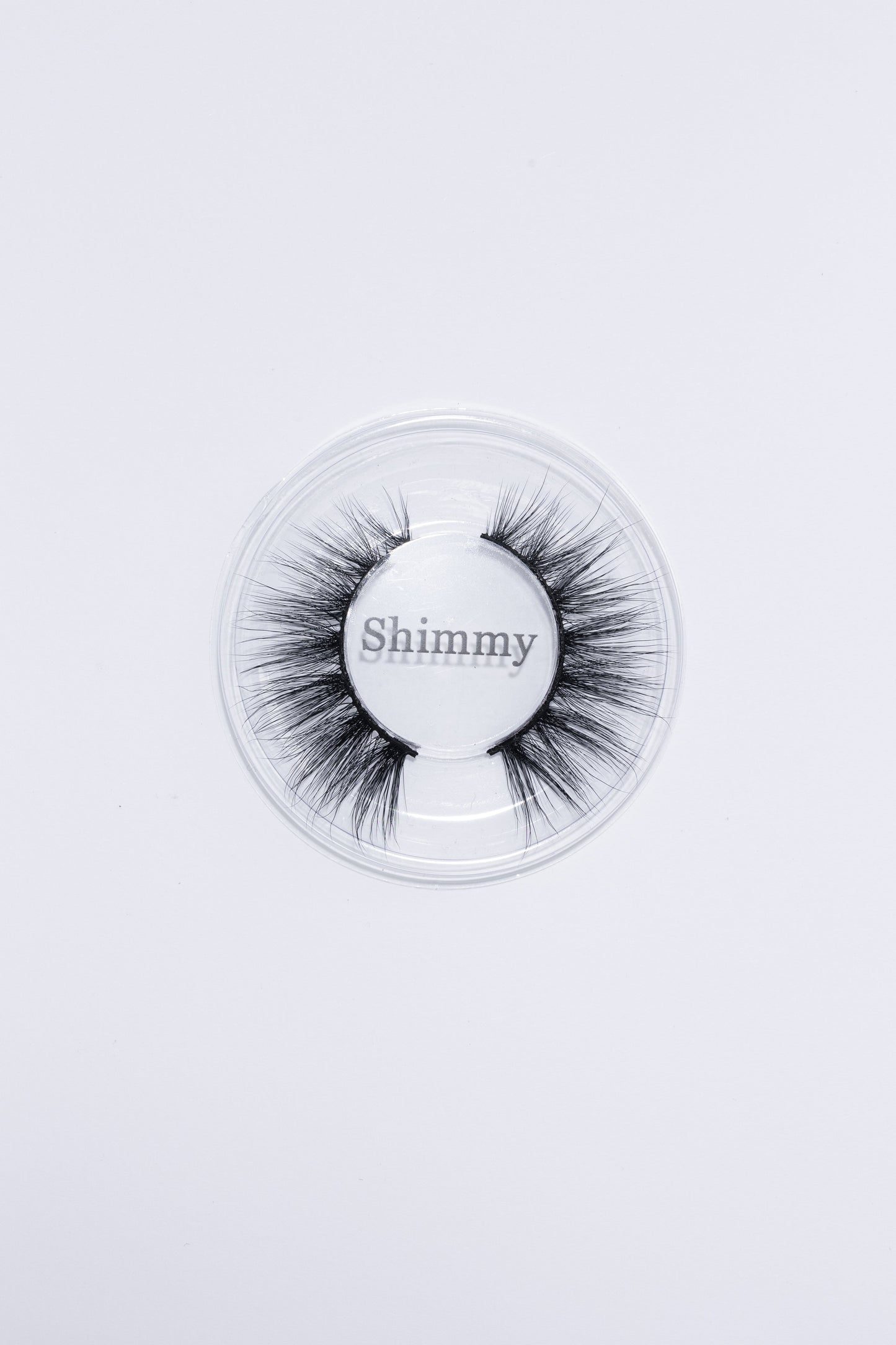 Shimmy eyelashes displayed in clear plastic box, showcasing the separation of lashes.