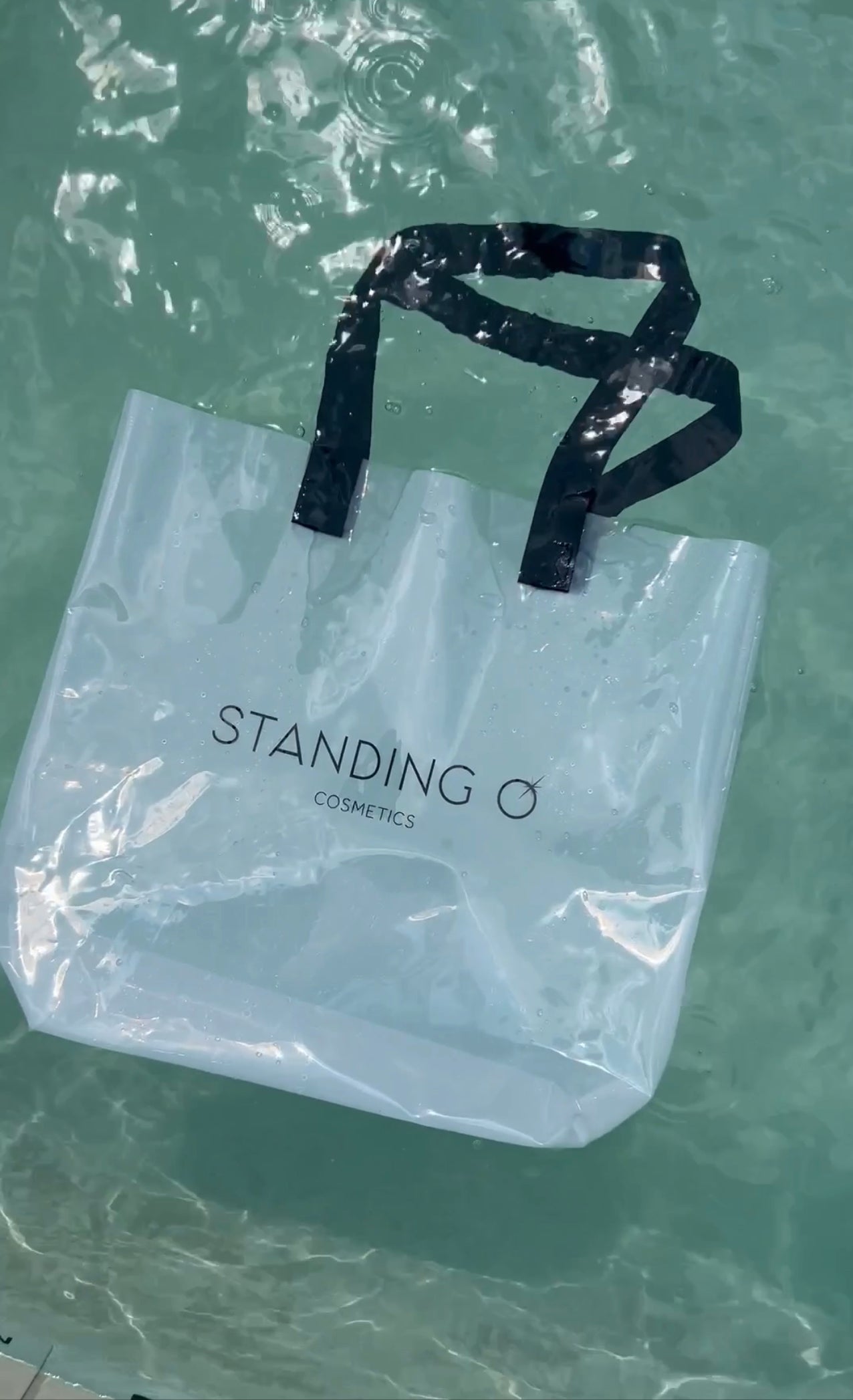 A plastic tote bag floating in water, showcasing its durability and waterproof water-resistant design.