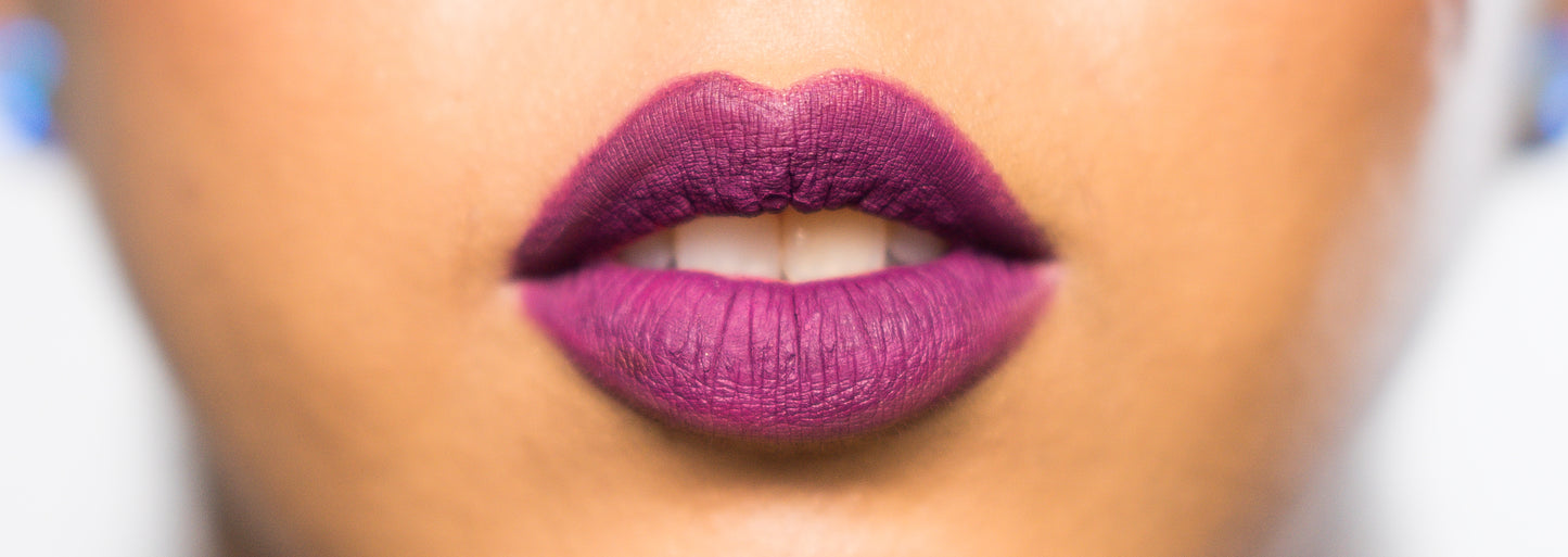 matte liquid lipstick & lip liner pencil shown on model in dark purple