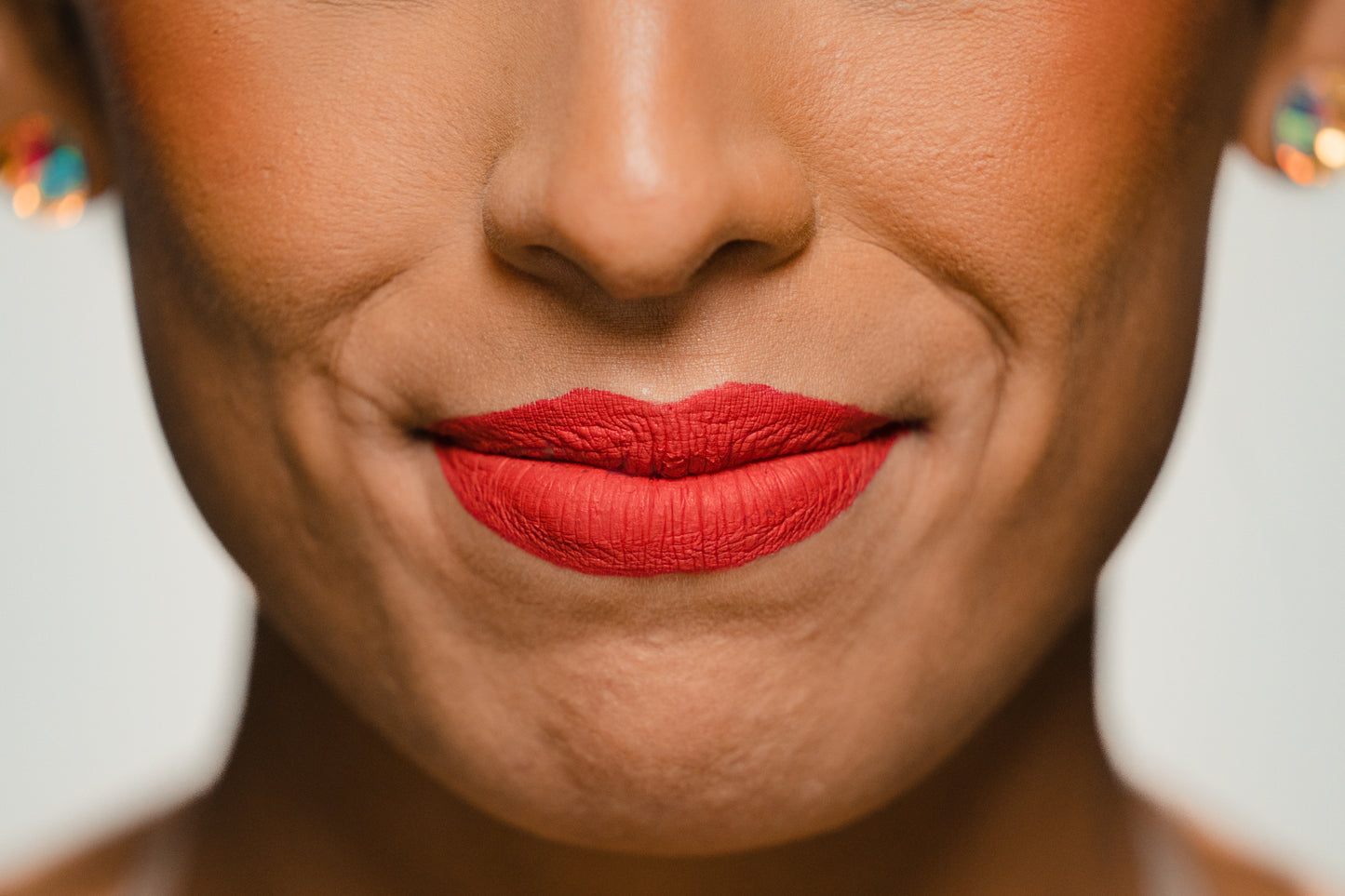 bright orange-red lipstick on model