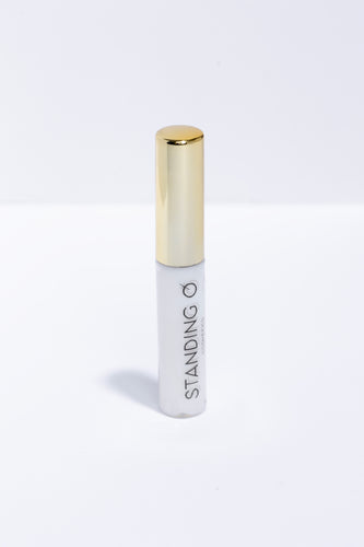 Tube Of White Lash Adhesive with Gold Top. Standing O Logo is imprinted on the tube.