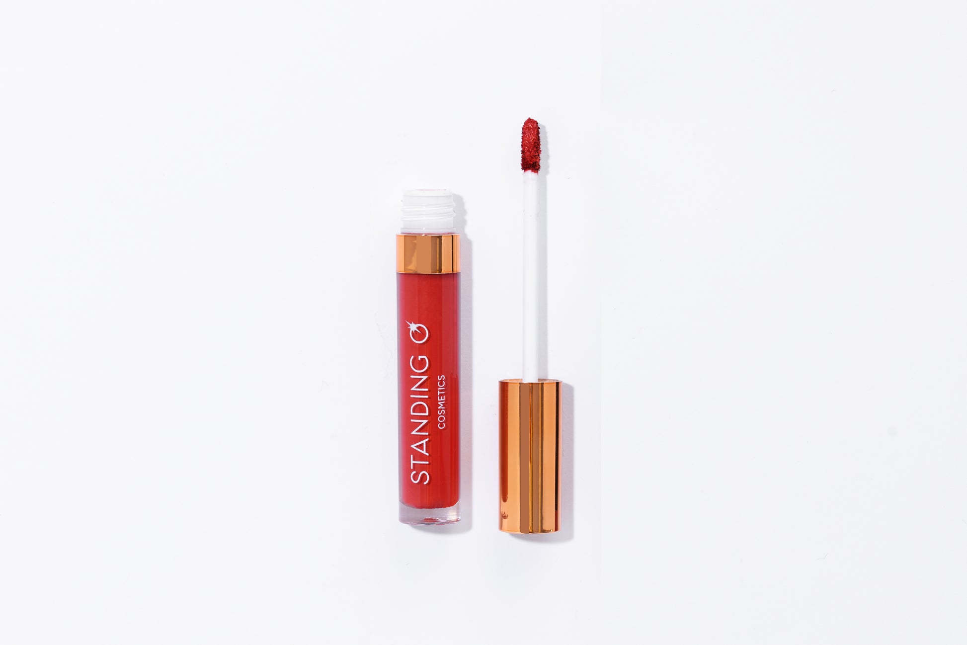 Tube of lipstick with a gold top shown open to showcase the applicator and color: classic red lipstick.