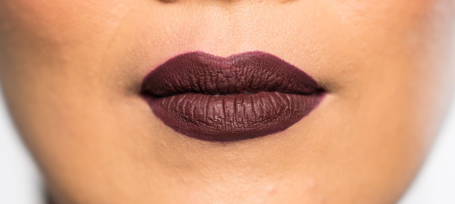 matte liquid lipstick & lip liner pencil shown on model in dark red, burgundy color